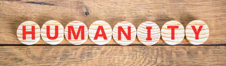 Humanity word symbol. Concept word Humanity on beautiful wooden circles. Beautiful wooden background. Business support help humanity word concept. Copy space.の写真素材
