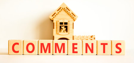 Comments comment word symbol. Concept word Comments on beautiful wooden blocks. Beautiful white...