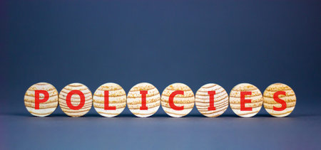 Policies word symbol. Concept word Policies on beautiful wooden circles. Beautiful grey background....