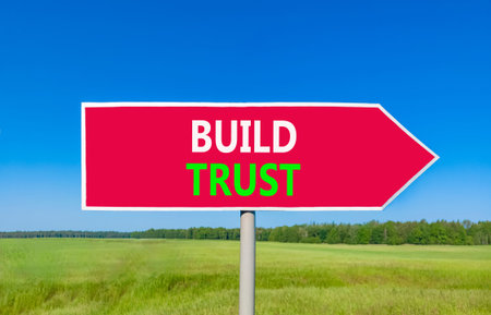 Build trust symbol. Concept words Build trust on beautiful red road sign. Beautiful blue sky green...