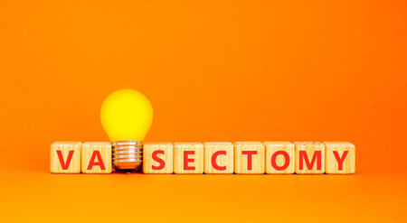 Vasectomy word symbol. Concept word Vasectomy on beautiful wooden blocks. Beautiful orange...