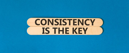 Consistency is the key symbol. Concept words Consistency is the key on beautiful wooden sticks....
