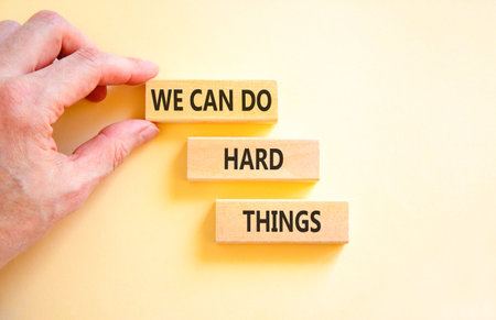 Support, help we can do hard things symbol. Concept words We can do hard things on beautiful wooden...