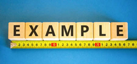 Example examples symbol. Concept word Example on beautiful wooden blocks. Beautiful blue background....