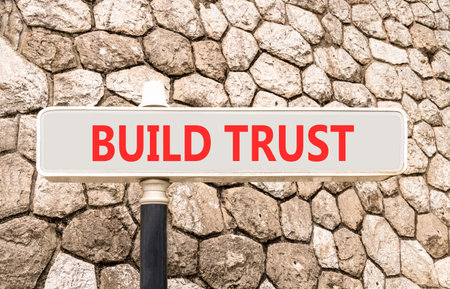 Build trust symbol. Concept words Build trust on beautiful big white road sign. Beautiful grey stone...