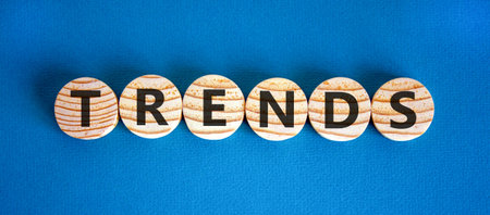 Trends trend word symbol. Concept word Trends on beautiful wooden circles. Beautiful blue...