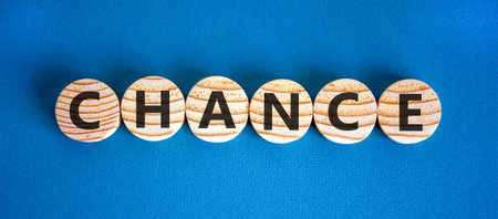 Chance symbol. Concept word Chance on beautiful wooden circles. Beautiful blue background. Business chance concept. Copy space.の写真素材