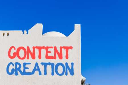 Time for content creation symbol. Concept words Content creation on beautiful white wall. Beautiful white wall and blue sky background. Business time for content creation concept. Copy space.の写真素材