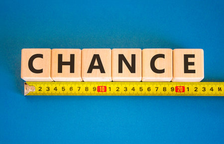 Chance symbol. Concept word Chance on beautiful wooden blocks. Beautiful blue background. Beautiful...