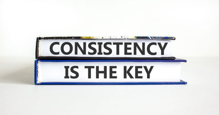 Consistency is the key symbol. Concept words Consistency is the key on beautiful books. Beautiful...