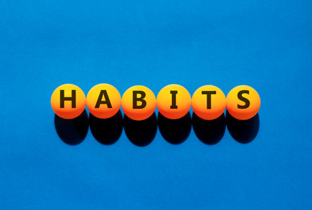 Habits support and help symbol. Concept word Habits on beautiful orange table tennis ping pong...