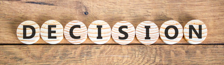 Decision word symbol. Concept word Decision on beautiful wooden circles. Beautiful wooden background. Business support help decision word concept. Copy space.の写真素材
