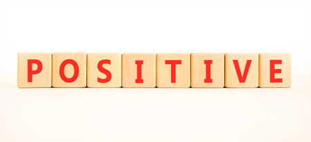 Positive word symbol. Concept word Positive on beautiful wooden blocks. Beautiful white background. Business support help positive word concept. Copy space.の写真素材