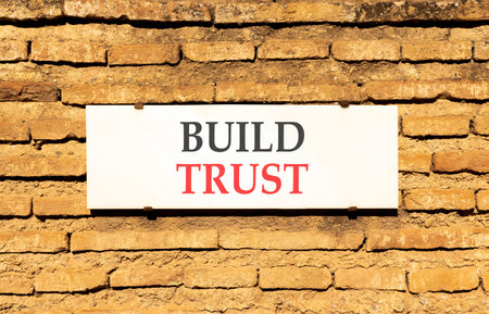 Build trust symbol. Concept words Build trust on beautiful big white sign plate. Beautiful old brown...
