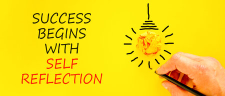 Self reflection symbol. Concept words Success begins with self reflection on beautiful yellow paper. Beautiful yellow background. Business success begins with self reflection concept. Copy space.の写真素材