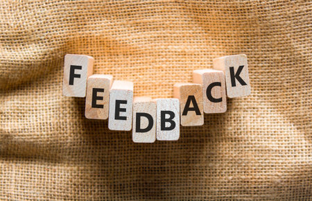Feedback word symbol. Concept word Feedback on beautiful wooden blocks. Beautiful canvas background....