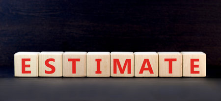 Estimate word symbol. Concept word Estimate on beautiful wooden blocks. Beautiful black background....