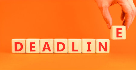 Deadline word symbol. Concept word Deadline on beautiful wooden blocks. Beautiful orange background....