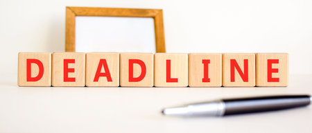 Deadline word symbol. Concept word Deadline on beautiful wooden blocks. Beautiful white background....