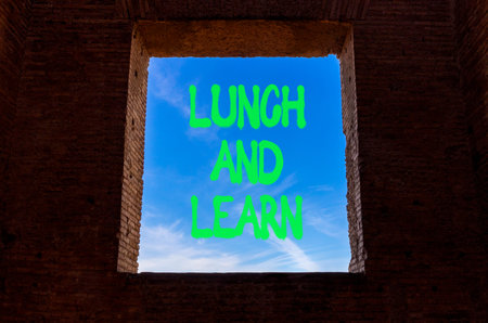 Lunch and learn symbol. Concept words Lunch and learn on beautiful blue sky in window in ancient...