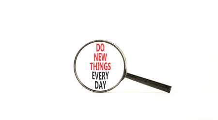 Do new things every day words symbol. Concept words Do new things every day in beautiful magnifying...