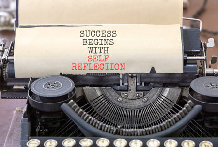 Self reflection symbol. Concept words Success begins with self reflection typed on old retro...