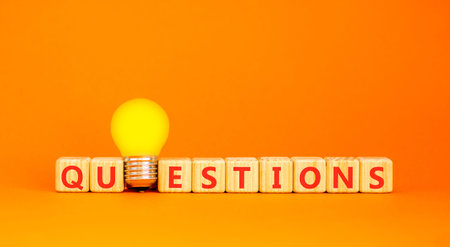 Question questions symbol. Concept word Questions on beautiful wooden blocks. Beautiful orange...