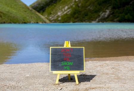 Tell or show symbol. Concept words Do not tell me, show me on beautiful black blackboard. Beautiful...