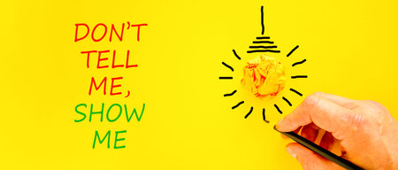 Tell or show symbol. Concept words Do not tell me, show me on beautiful yellow paper. Beautiful...