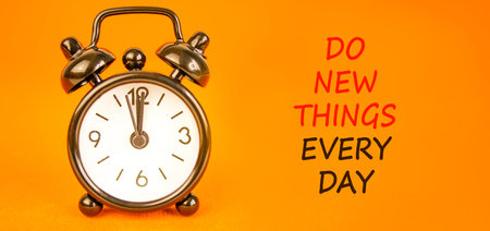 Do new things every day words symbol. Concept words Do new things every day on beautiful orange...