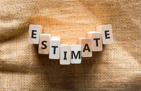 Estimate word symbol. Concept word Estimate on beautiful wooden blocks. Beautiful canvas background....