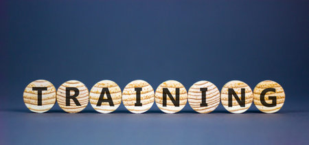 Training word symbol. Concept word Training on beautiful wooden circles. Beautiful grey background....