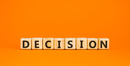 Decision word symbol. Concept word Decision on beautiful wooden blocks. Beautiful orange background....