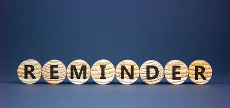 Reminder word symbol. Concept word Reminder on beautiful wooden circles. Beautiful grey background. Business support help reminder word concept. Copy space.の写真素材