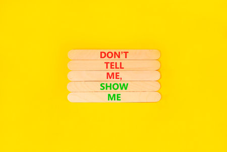 Tell or show symbol. Concept words Do not tell me, show me on beautiful wooden sticks. Beautiful...