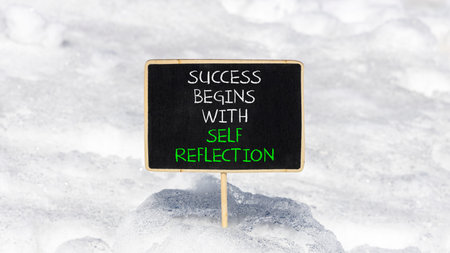 Self reflection symbol. Concept words Success begins with self reflection on beautiful black...