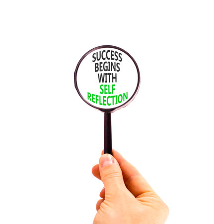 Self reflection symbol. Concept words Success begins with self reflection in beautiful magnifying glass. Beautiful white background. Business success begins with self reflection concept. Copy space.の写真素材