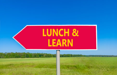Lunch and learn symbol. Concept words Lunch and learn on beautiful red road sign. Beautiful blue sky...