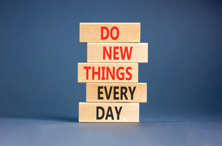 Do new things every day words symbol. Concept words Do new things every day on beautiful wooden...