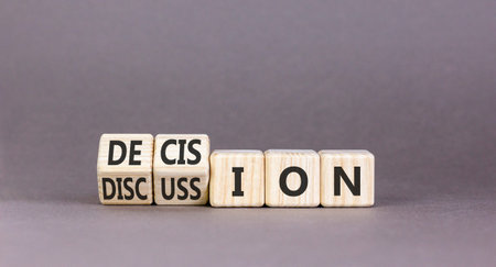 Discussion and decision symbol. Concept words Discussion and Decision on beautiful wooden cubes. Beautiful grey table grey background. Business discussion and decision concept. Copy space.の写真素材