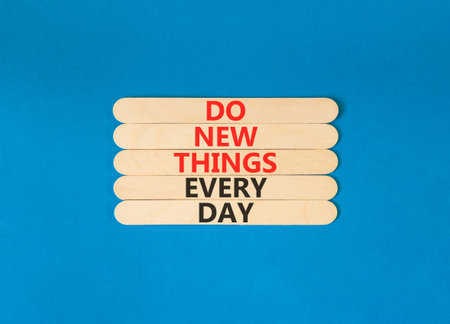 Do new things every day words symbol. Concept words Do new things every day on beautiful wooden...