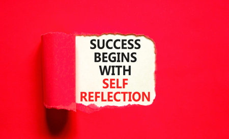 Self reflection symbol. Concept words Success begins with self reflection on beautiful white paper. Beautiful red paper background. Business success begins with self reflection concept. Copy space.の写真素材