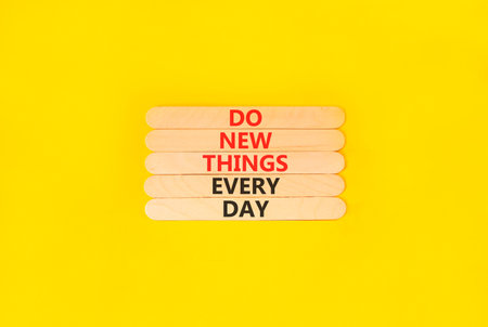 Do new things every day words symbol. Concept words Do new things every day on beautiful wooden...