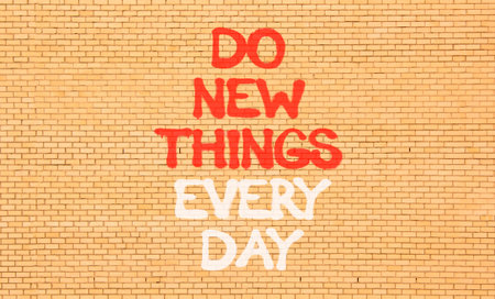 Do new things every day words symbol. Concept words Do new things every day on beautiful brick wall....