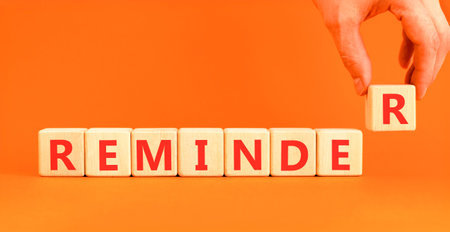 Reminder word symbol. Concept word Reminder on beautiful wooden blocks. Beautiful orange background....
