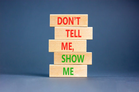 Tell or show symbol. Concept words Do not tell me, show me on beautiful wooden blocks. Beautiful...