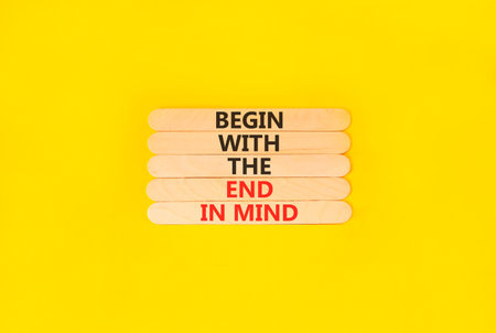 Begin with the end in mind symbol. Concept words Begin with the end in mind on beautiful wooden sticks. Beautiful yellow paper background. Business begin with the end in mind concept. Copy space.の写真素材