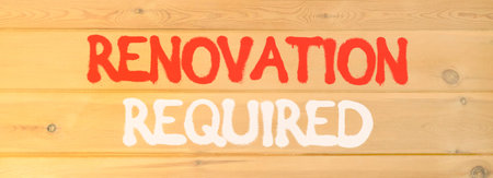 Renovation required words symbol. Concept words Renovation required on beautiful wooden wall....