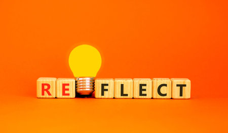 Reflect word symbol. Concept word Reflect on beautiful wooden blocks. Beautiful orange background....