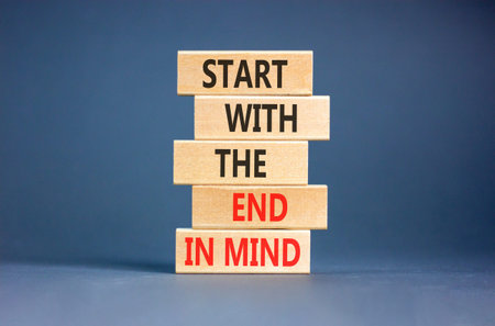 Start with the end in mind symbol. Concept words Start with the end in mind on beautiful wooden blocks. Beautiful grey paper background. Business start with the end in mind concept. Copy space.の写真素材
